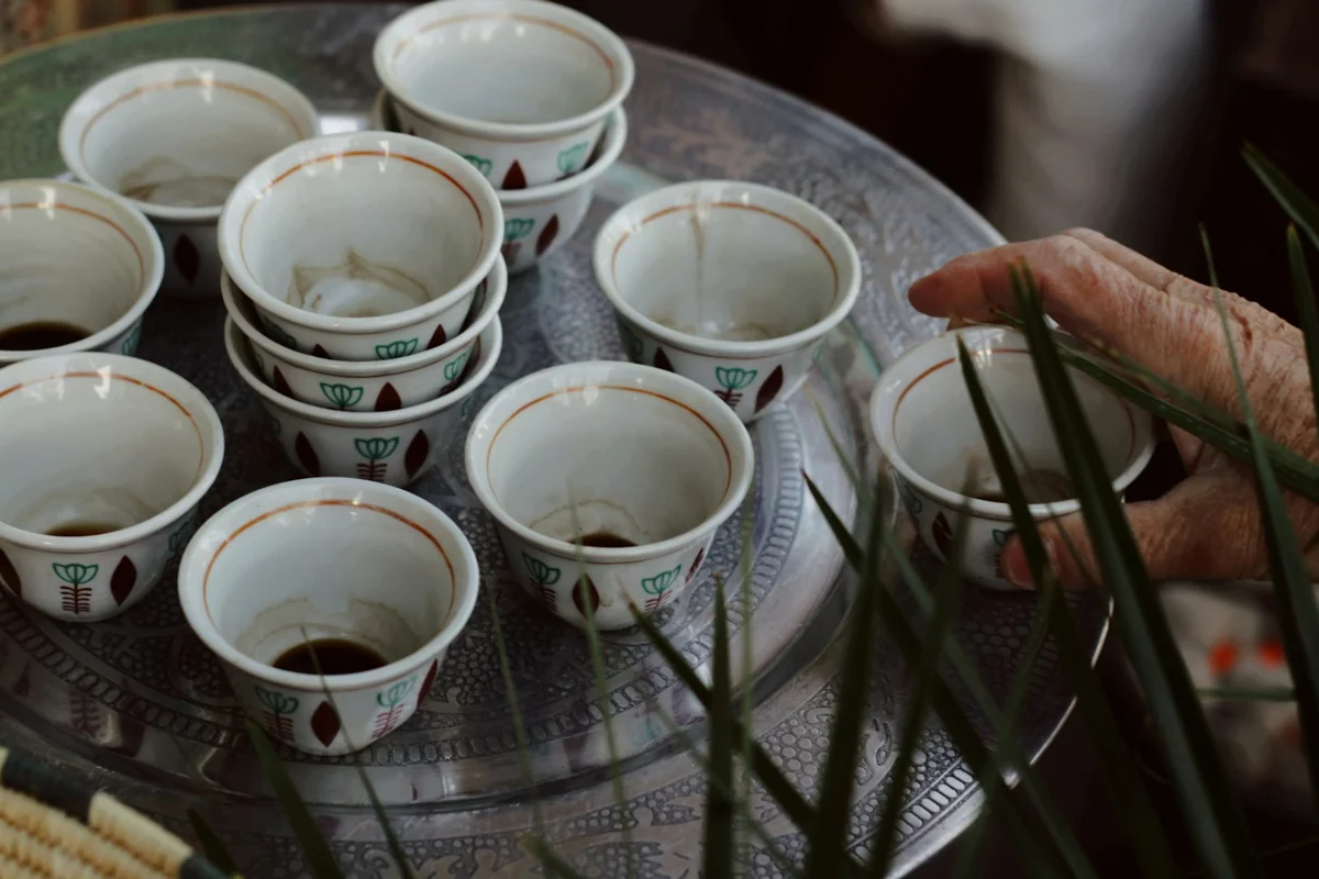 Small patterned coffee cups gathered on a silver tray